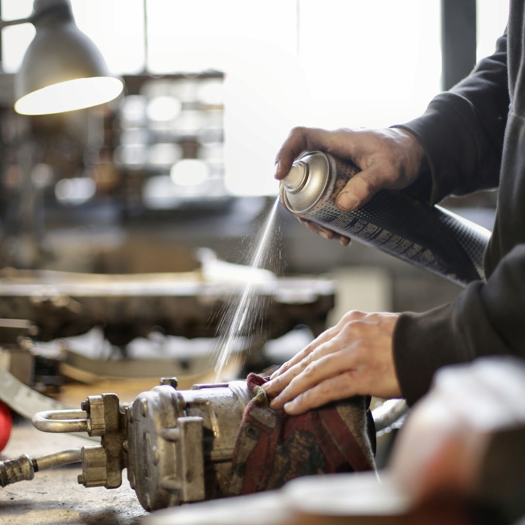 spraying lubricant on engine