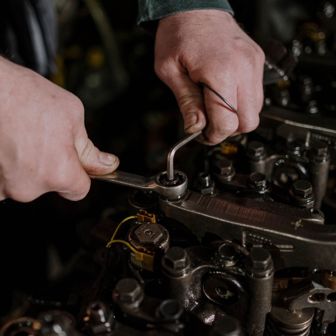 using a wrench to rebuild an engine